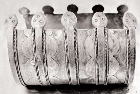 over 100 years old antique Turkish tribal bracelet with grunge pattern and snake symbols on textured background. の写真素材