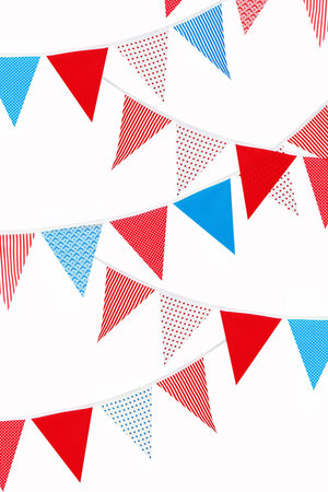 festive red, blue and white bunting flags on white backgroundの写真素材