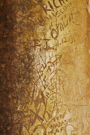 defaced ancient culture wall with carved graffiti in Ephesus, Turkey.の写真素材