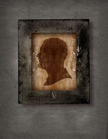 drawing of a man face in old-fashioned silhouette style in a frame on grunge backgroundの写真素材