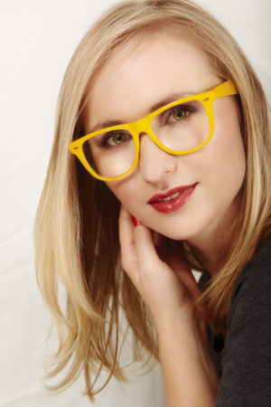 beautiful blond woman with geek yellow glasses.の写真素材