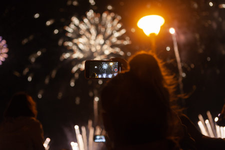 young girl takes fireworks on the phone