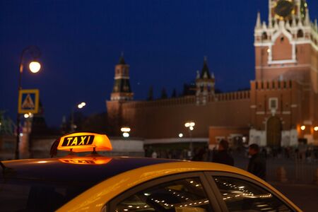The big taxi sign on the background of night city. Moscow taxiの写真素材