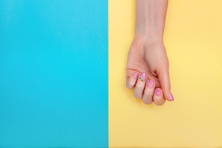 Manicure. Hands of an adult woman with a beautiful manicure on the nails. Gentle hands with natural manicure, clean adult skin. amazing nailsの写真素材