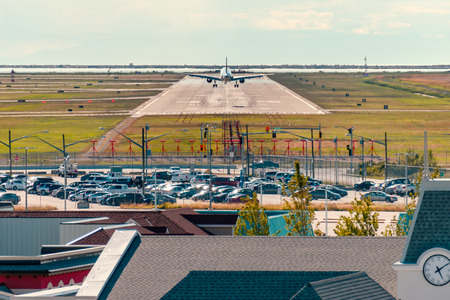 A beautiful landing of an airplane on the runway in a modern airportの写真素材