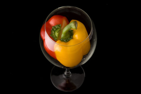 Beatiful dissected Pimiento united in bright goblet on black backgroundの写真素材