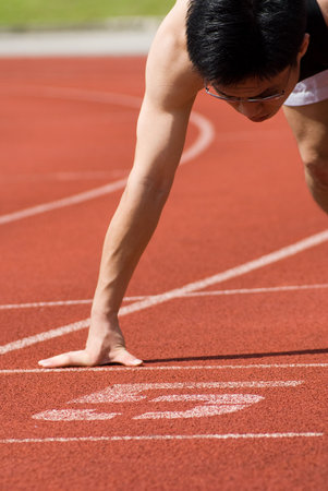 An asian male athlete is ready to start off. Its abstract meaning is the business is ready with all...