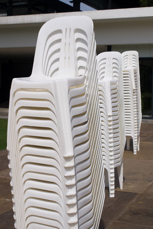 Stacks of white chair outdoor in parkの写真素材