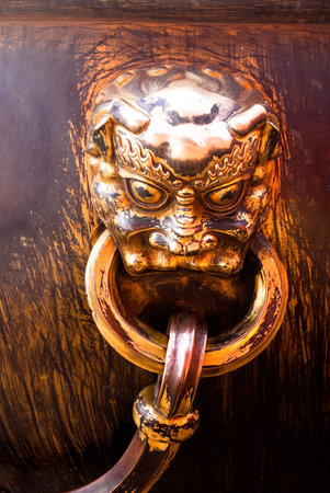 metal decoration on antique water can in forbidden cityの写真素材