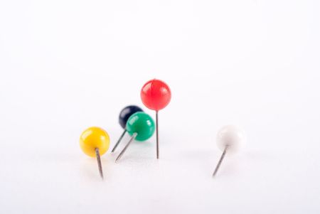 dispersed colorful pins isolated with red standing outの写真素材
