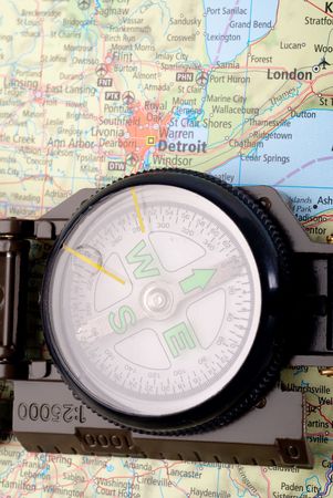 steel compass on travel map of detroitの写真素材