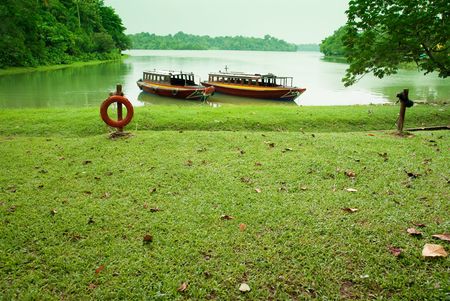 lakeside with boats parking in green backgroundの写真素材