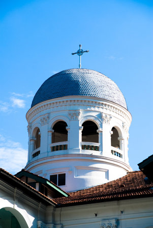 white church roof exterior against blue skyの写真素材