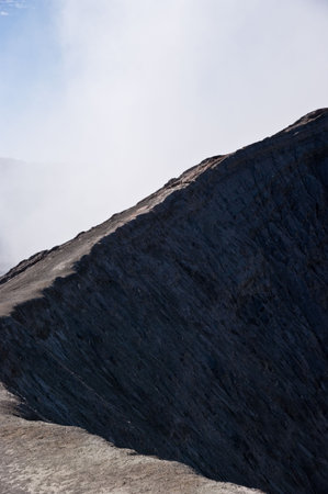 People climbing famous volcano mountain bromo craterの写真素材