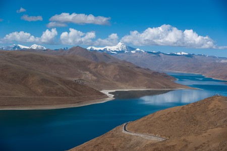 Blue lake with surrounding mountains in great tibet areaの写真素材