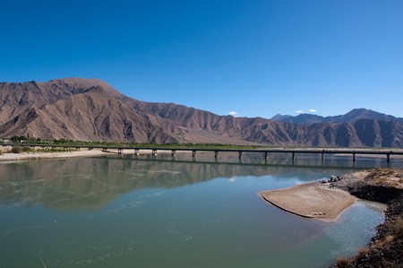 Blue lake with surrounding mountains in great tibet areaの写真素材