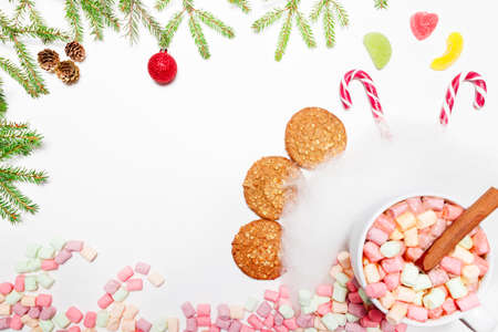 Cup of hot aromatic chocolate drink with marshmallows on a white background, Christmas decorations. A drink for the winter. Top view. Copy space.の写真素材