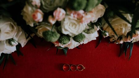 two gold wedding rings with flowersの写真素材
