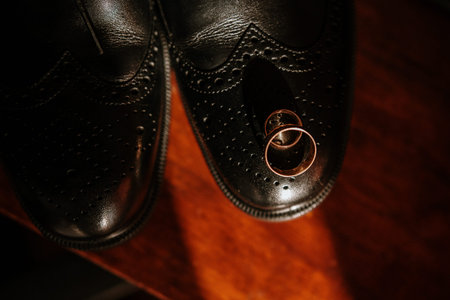 two golden wedding rings bride on shoes