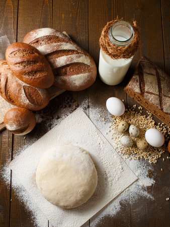Fresh dough with flour on a paper napkin decorated with rye bread flour, quail eggs and wheat grainsの写真素材