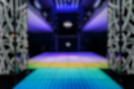 Bokeh background color disco. Blurred background nightclub spotlight on disco. Disco lights in the shape of a star. Blur background in the form of starsの写真素材