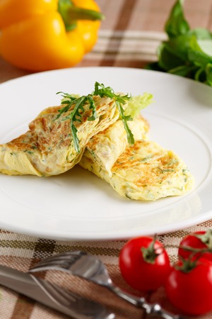 Close-up of scrambled eggs with arugula on white dishの写真素材