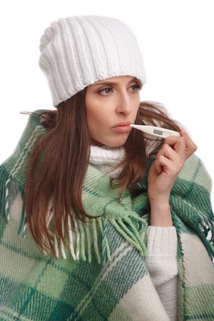 Sick girl with a thermometer on a white background, isolate, flu, coldsの写真素材