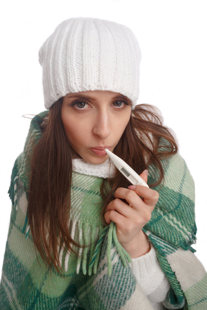 Sick girl with a thermometer on a white background, isolate, flu, colds. Top viewの写真素材