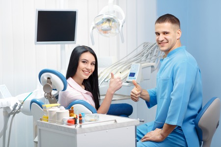 Pretty woman patient shows Like in the dental office. People, medicine, stomatology and health care conceptの写真素材