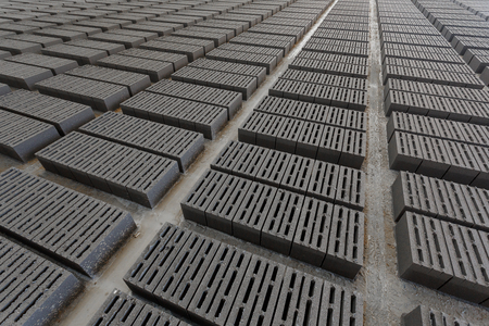 Stack of bricks. Manufacturing of aerated concrete blocks. Manufacturing of cinder block. The plant manufactures building material. The plant produces a cinder block. Cinder block-building material.の写真素材