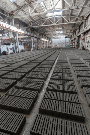 Stack of bricks. Manufacturing of aerated concrete blocks. Manufacturing of cinder block. The plant manufactures building material. The plant produces a cinder block. Cinder block-building material.の写真素材