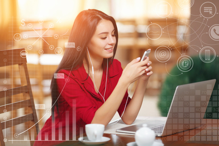 Young business woman using phone in coffee shop. Successful business woman. Business infographicの写真素材