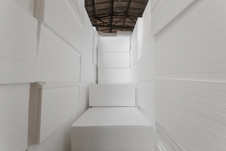 Polystyrene insulation boards. Polystyrene plates warehouse. Polystyrene Stackの写真素材