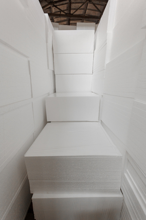 Polystyrene insulation boards. Polystyrene plates warehouse. Polystyrene Stackの写真素材