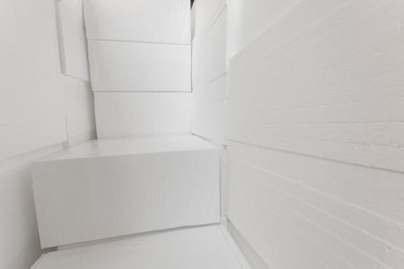Polystyrene insulation boards. Polystyrene plates warehouse. Polystyrene Stackの写真素材