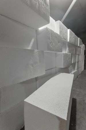 Large blocks of polystyrene. Polystyrene insulation boards. Polystyrene plates warehouse. Polystyrene Stackの写真素材