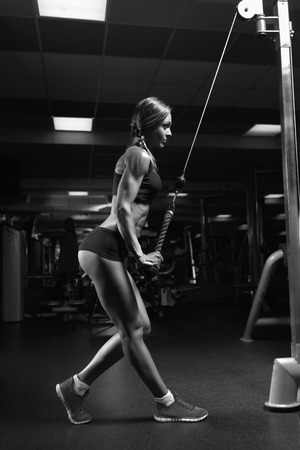 Black and white photo fitness woman in the gym. Young woman doing fitness exercises in the gym.の写真素材