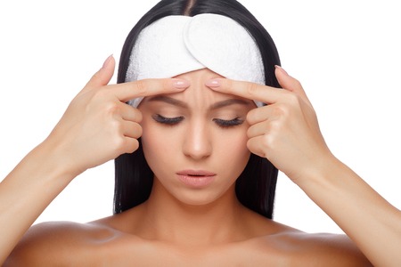 Young woman squeezing her pimple, removing pimple from her face. Woman skin care concept. Acne spot pimple spot skincare beauty care girl pressing on skin problem face.の写真素材