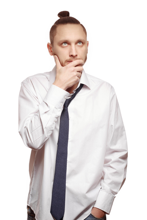 Portrait of young man in white shirt on white background. Man with beard in white shirt and loosened his tieの写真素材