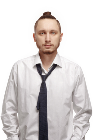 Portrait of young man in white shirt on white background. Man with beard in white shirt and loosened his tieの写真素材