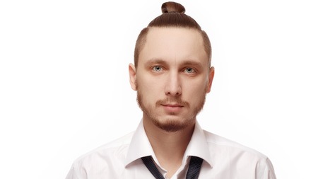 Portrait of young man in white shirt on white background. Man with beard in white shirt and loosened his tieの写真素材