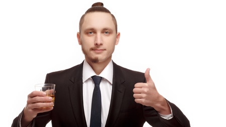Half shaved. Handsome young man with half shaved face. Half shaven young man holding a glass with alcohol shows Likeの写真素材