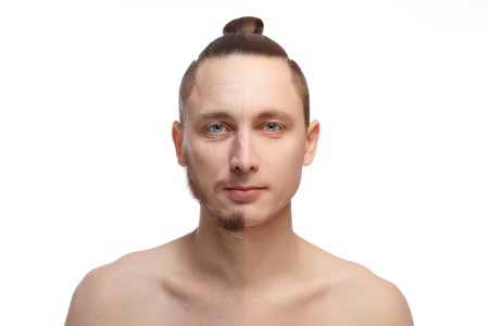 Half shaved. Handsome young man with half shaved face looking at camera. Young man portrait, isolated on a white background. Before and after cosmetic or plastic procedure, anti-age therapy.の写真素材
