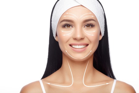 Massage facial lines. Closeup Happy Woman in Hairband, her Face with a Perfectly Clean Skin. Skin Care, Cosmetics and Massage Concept. Massage linesの写真素材