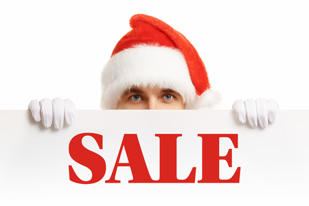 Santa Claus with a banner sales. Santa Claus peeping from behind a banner. Christmas banner sales. Christmas sale.の写真素材