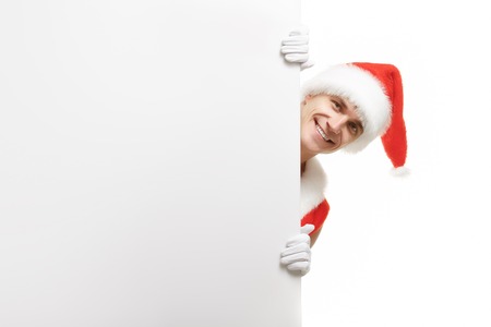 Santa Claus with a banner sales. Santa Claus peeping from behind a banner. Christmas banner sales. Christmas sale. Merry Santa Claus isolated on white background. Sales banner.の写真素材