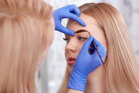 Permanent makeup of eyebrows for blonde woman.の写真素材