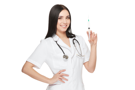 Positivity female doctor posing and showing injection with vaccine.の写真素材