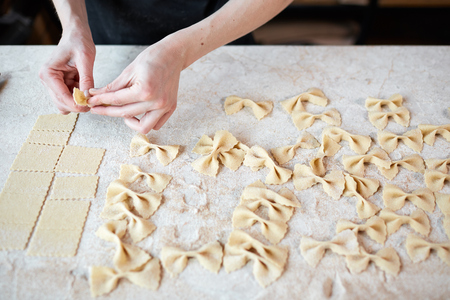 Unrecognizable cook making farfalleの写真素材