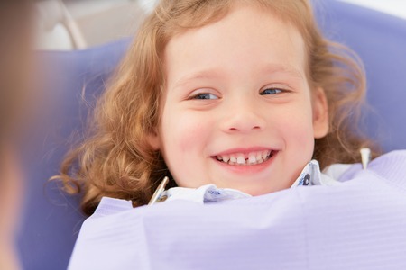 Smiling girl at dentistの写真素材